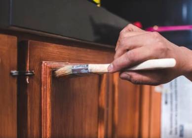 Wood cabinet refinishing using brush for smooth stain finish