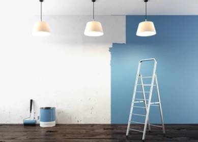 Interior painting in progress with blue paint and ladder setup