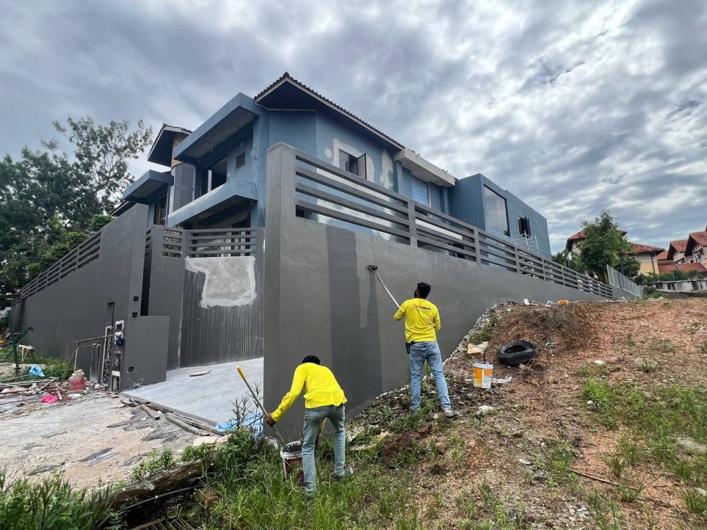 Tukang cat Painthero mengecat dinding luar rumah.