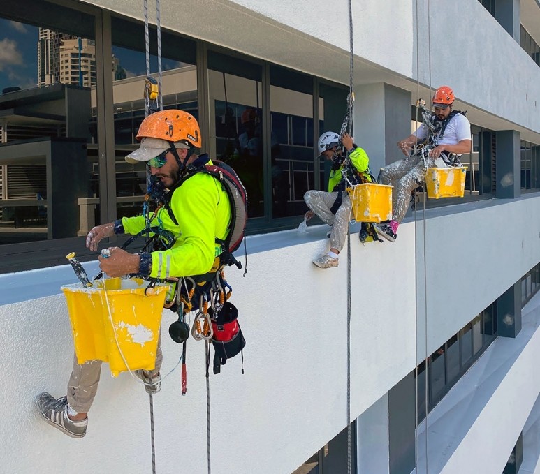 High-rise building painting via rope access